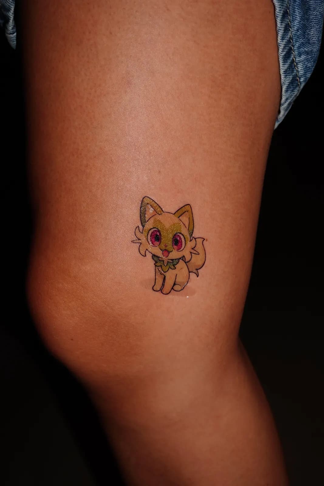 Tatuaje temporal a color de Sprigatito, de Pokémon, aplicado en la pierna